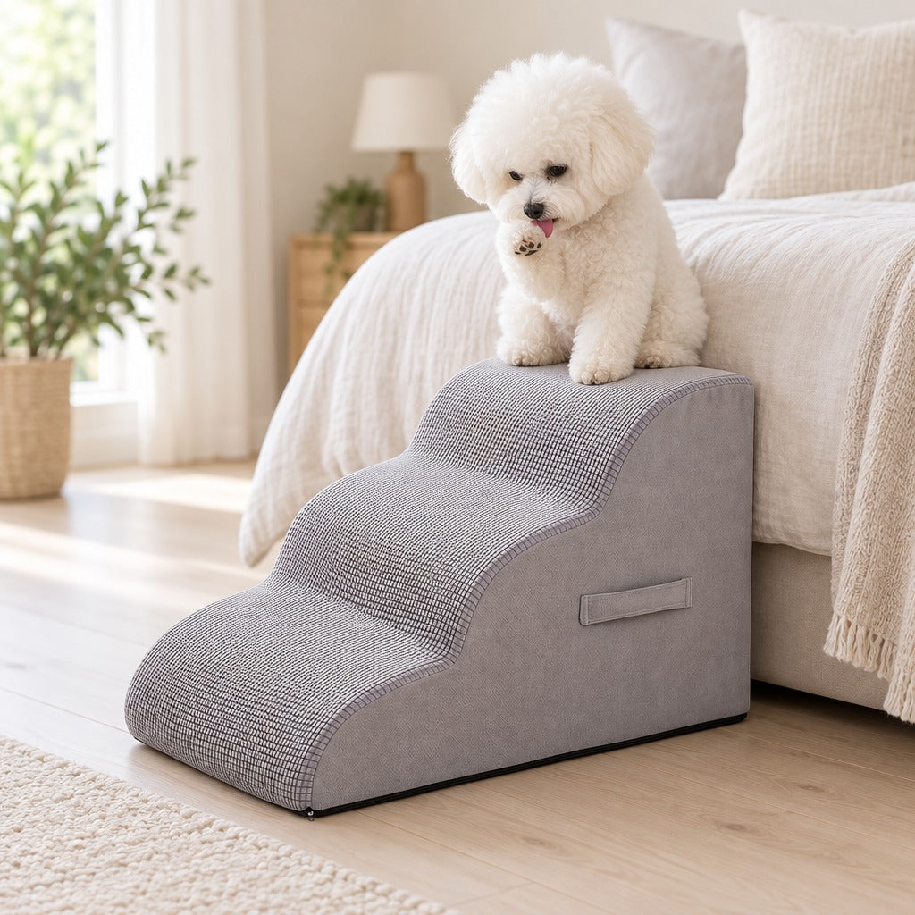 Bichon frisé blanc assis sur la marche haute de l'escalier gris perle, au pied d'un lit clair.