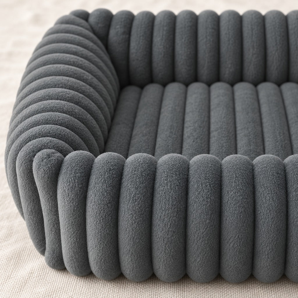 Gros plan du velours côtelé gris ardoise du panier pour chien, cannelures du rebord et de la surface de couchage.