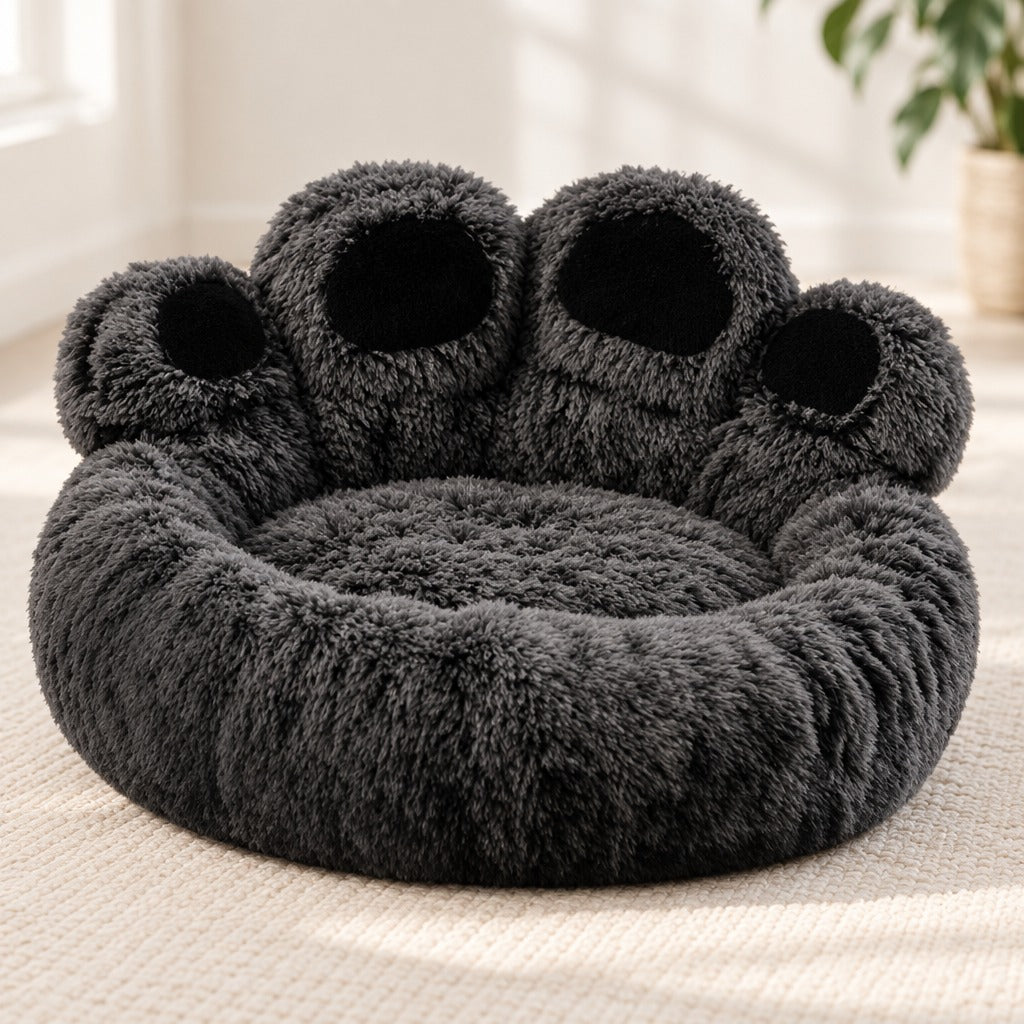 Le couchage pour chien anthracite seul, vu de trois quarts, ses quatre coussinets noirs visibles.